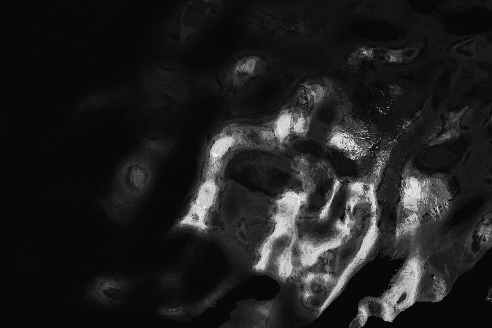 High-contrast abstract forms emerging from darkness, used to represent structural problems on a site becoming visible under review